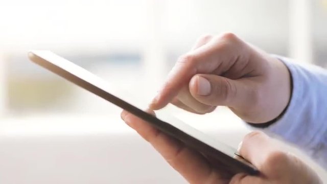 man hand touching tablet computer surface touchscreen pad