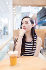 girl drinking a glass of iced drinks