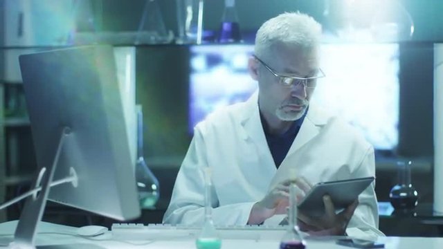 Scientist is Using Tablet and Computer in Laboratory