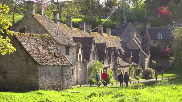 Tourists walk through the beautiful and well preserved old English town of Bilbury.