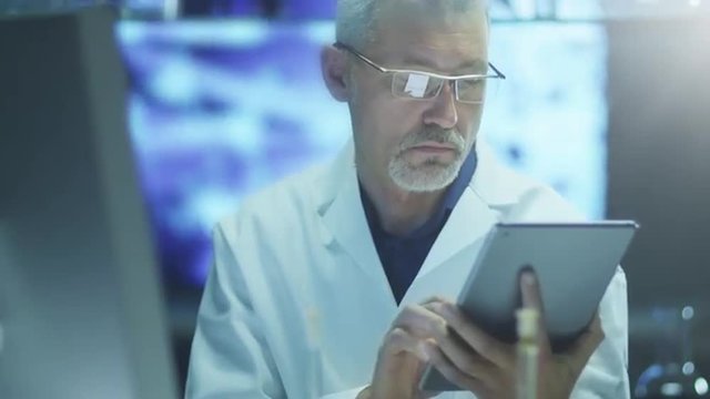 Scientist is Using Tablet in Laboratory