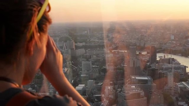 Tourist taking photograph sunset london skyline cityscape view from The Shard