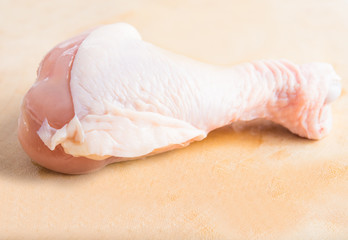 Fresh chicken legs arrangement on kitchen cutting board