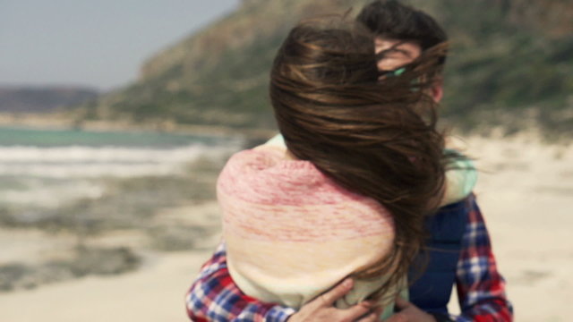 Young couple kissing and hugging on beach