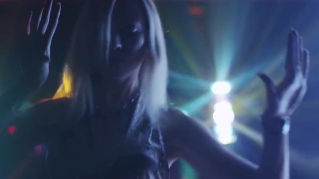 Teen Blond Girl is Dancing in Nightclub