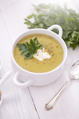 A delicious pea cream with aromatic spices on a wooden table.