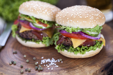 Beef burgers on a wooden board with aromatic spices