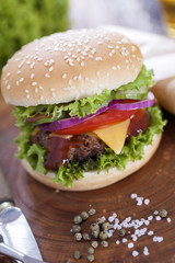 Beef burgers on a wooden board with aromatic spices