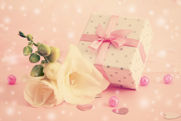 Beautiful little gift box and freesia flower on pink background