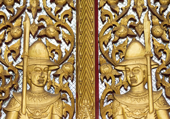 Fototapeta na wymiar Gate of Buddhism temple with golden soldier sculpture decorati