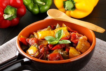 Peperonata: peppers cut into slices and baked in a pan - 91613422