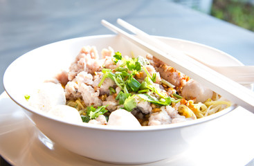 bowl of egg noodles with minced prok and fish balls