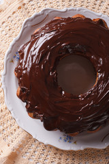 fancy bread cake with chocolate icing close-up. Vertical top view

