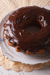 fancy bread cake with chocolate icing close-up. Vertical
