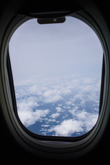 Clouds and sky from airplane window 