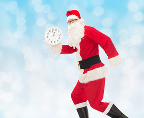 man in costume of santa claus with clock