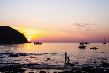 People in seascape with beautiful light from the sun