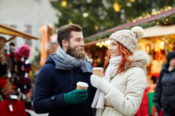 Fototapeta premium happy couple drinking coffee on old town street