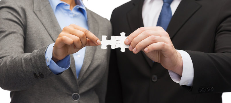 businessman and businesswoman with puzzle pieces