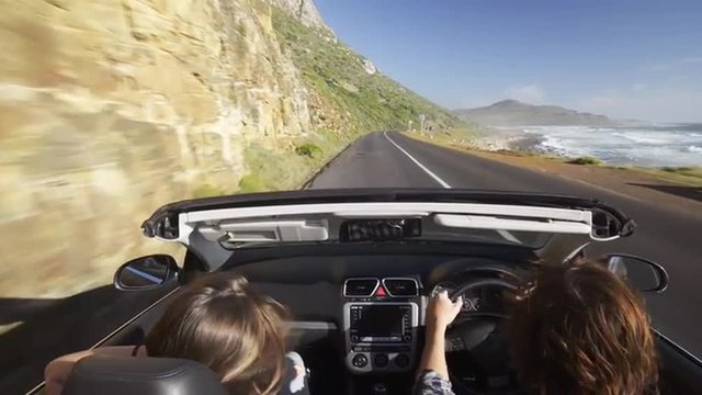 Couple driving convertible car cabriolet cape town south africa steadicam shot