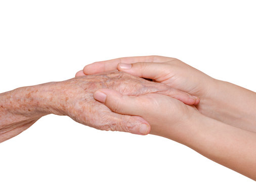 Young woman holding her grandmother hand over white background