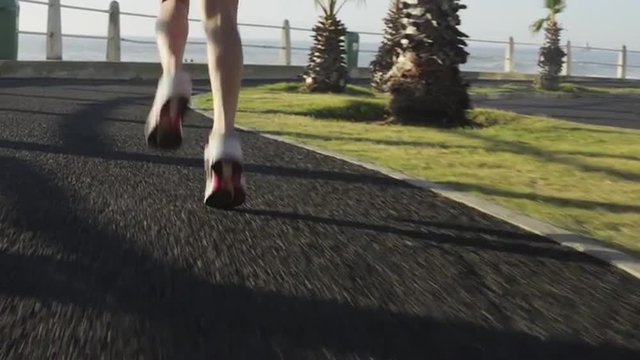 Mixed race woman runner running on road