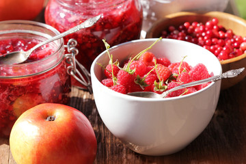 Raspberry, cranberry, apple jam ( marmalade )  on a rustic wooden table