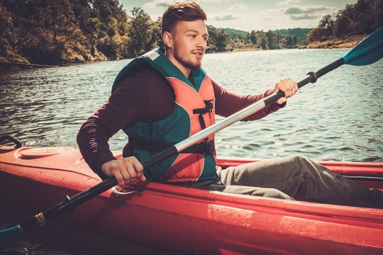 Kayaker with paddle on a boat