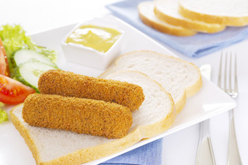 Dutch meat croquettes ('kroket') and bread on a plate