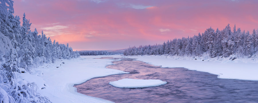 Sunrise over a river in a winter landscape, Finnish Lapland
