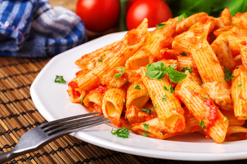 Penne with roasted chicken in tomato sauce