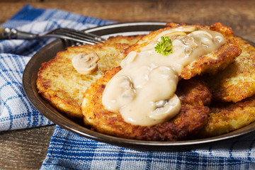 Homemade potato pancakes served with mushroom sauce and mushroom