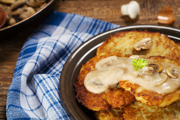 Homemade potato pancakes served with mushroom sauce and mushroom