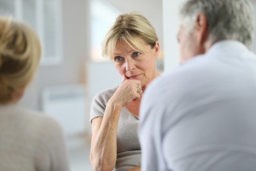 Senior woman attending group therapy