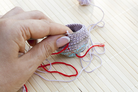 Crochet woven piece in hande close-up, selective focus