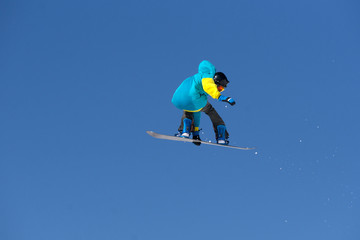 Snowboarder jumps in Snow Park