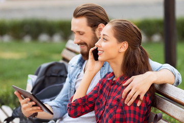 Happy couple sitting on the bench 