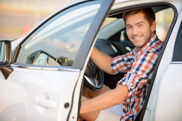 Upbeat boy sitting in the car 