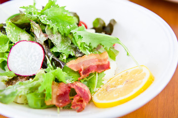 Closeup to salad with lettuce and bacon