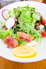 Closeup to salad with lettuce and bacon
