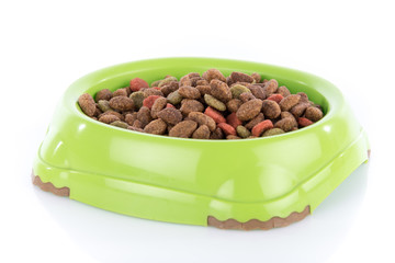 Cat food granules in a green bowl