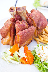 German BBQ pork knuckle with french fries and salad