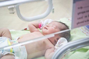 Obraz na płótnie Canvas first day of asian newborn baby in Incubator care at nursery