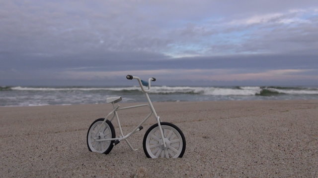 Toy bicycle in the resort beach sand by the sea
