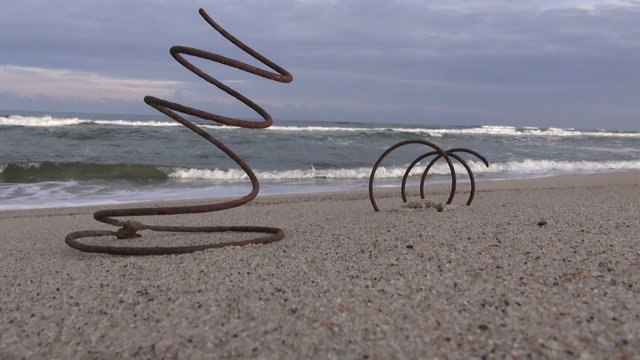 Old rusted iron spring by the sea