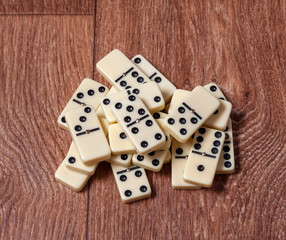 domino pieces on the brown wooden table background