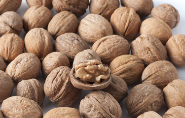 pile of walnuts in the foreground represent a healthy diet