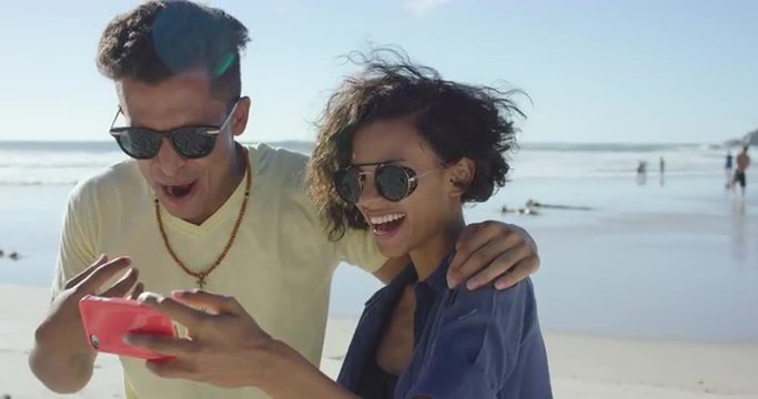 beautiful Mixed race couple taking selfies on the beach