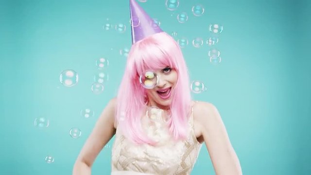 Single woman is sad in bubble shower slow motion photo booth blue background