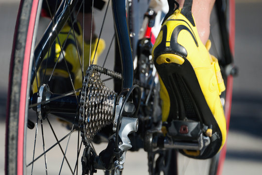 Racing- bike detail on gear wheels and feet
